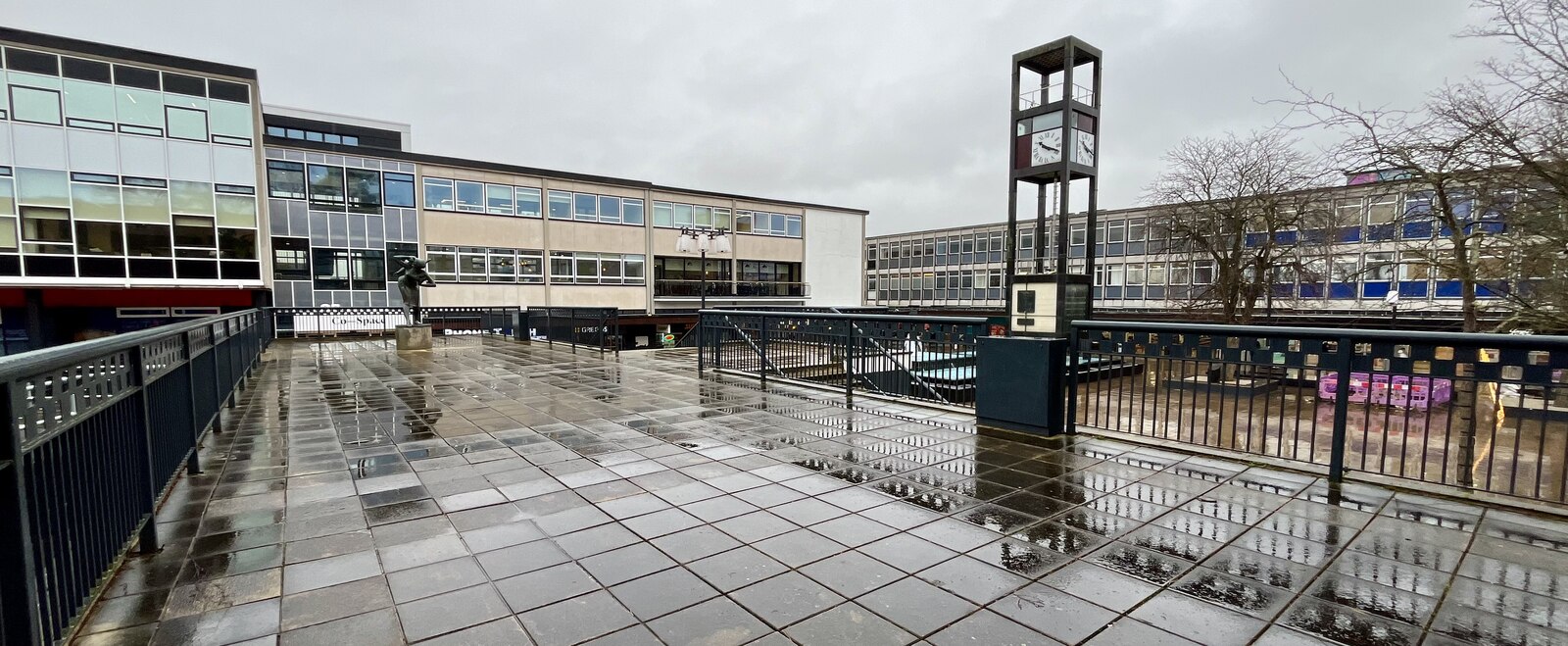 Stevenage town square with its clock tower on a wet winter morning